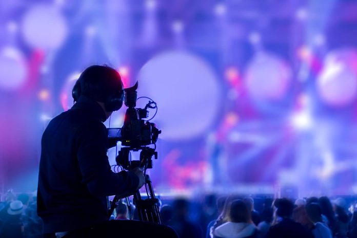 Cameraman recording a live music show.